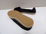 pair of black and white espadrills on a white surface
