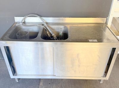 a stainless steel sink with two sinks and a faucet in it