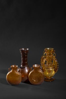 three vases and a vase on a table with a black background