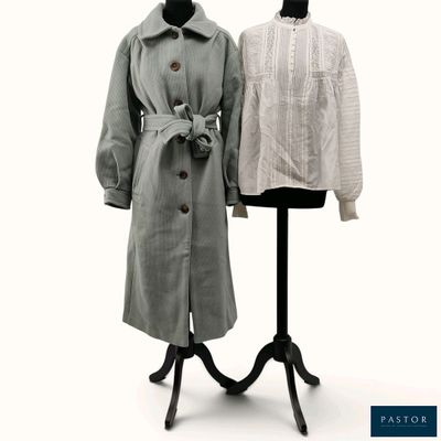 two coats on a mannequin stand on a white background