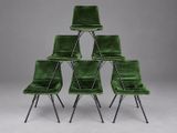 a set of six green velvet chairs with metal legs