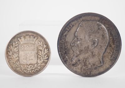 two silver coins, one with a crown and the other with a crown on it