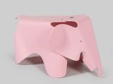 a small pink elephant that is sitting on a table