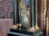 a clock that is sitting on a table in front of a door