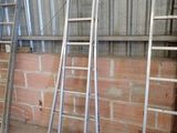 three ladders leaning against a wall in a building