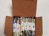 a cardboard box filled with assorted items on a white surface
