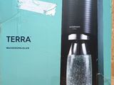 a soda streamer in the box on the table