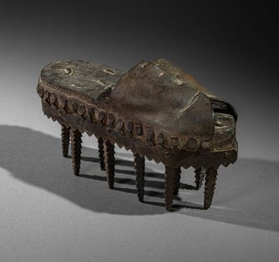an old wooden foot stool sitting on top of a white surface