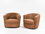 pair of mid - century style swive chairs in tan leather