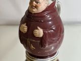 a figurine of a man with a hat on a table