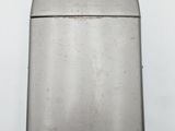 an old silver lighter sitting on top of a white table