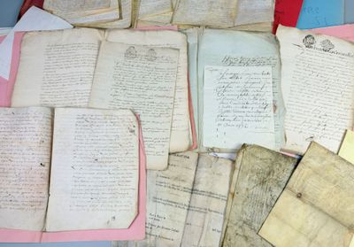 a pile of old papers sitting on top of a table