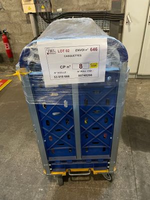 a blue cart with a sign on it in a warehouse