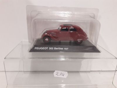 a red toy car in a clear display case