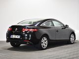 the rear end of a black car parked in a room
