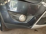 a close up of a front bumper of a car that has been dented