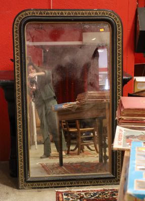 a mirror that is sitting on the floor in front of a table