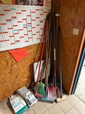 a pile of baseball bats and other baseball equipment on the floor