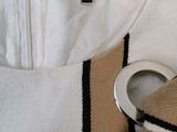 a white shirt with a black and white stripe on it and a pair of scissors