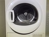 a washing machine that is sitting in the corner of a room