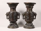 pair of antique bronze vases with handles and handles on pedestals