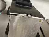 stainless steel counter top with a frying pan on top of it