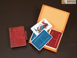 une boîte de cartes à jouer et un portefeuille posés sur une table