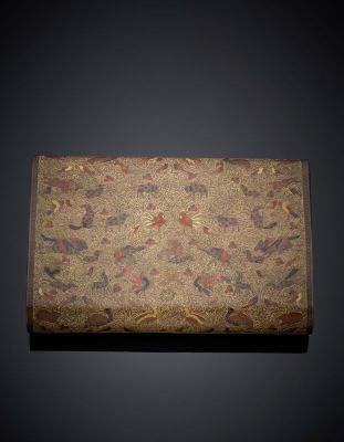 an old box with a design of birds and flowers on it
