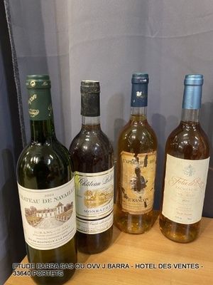 several bottles of wine are lined up on a wooden shelf