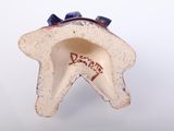 a small ceramic object with a star on it