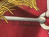 a close up of a red tie with a gold design on it