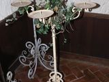 wrought iron candelab with three candles on top of it