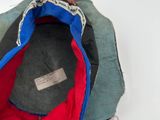 a red, blue, and black hat on a white surface