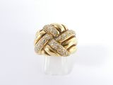 a close up of a gold ring with diamonds on a white surface
