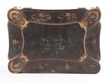 a black and gold tray on a white surface