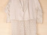 lacy white blouse with lace detail on shoulders and cuffs