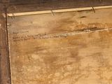 a wooden box with writing on it sitting on the floor