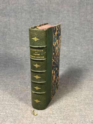 a close up of a green book on a gray surface