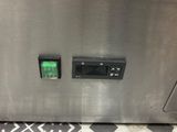 an image of a stainless steel oven with a green button