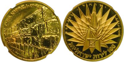 a close up of a gold coin with a leaf on it