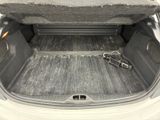 a trunk of a car with a large rock in the back