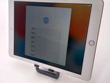tablet computer sitting on top of a white table with a screen on top of it