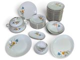many different types of plates and bowls on the table