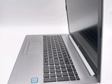 a silver laptop with a blue sticker on the screen