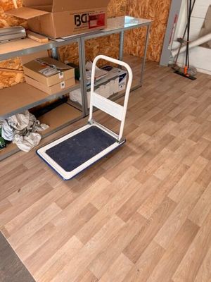 une pièce dans laquelle se trouvent quelques cartons posés sur un chariot