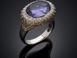 a tan and white gold ring with a tan sapphire stone surrounded by diamonds