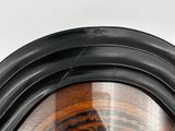 a close up of a wooden chair with a black frame