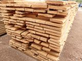 a pile of wood that is stacked up on the ground