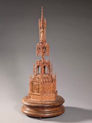 an image of a wooden sculpture of a church on a pedestal