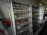 many racks of food in a large room with a ladder